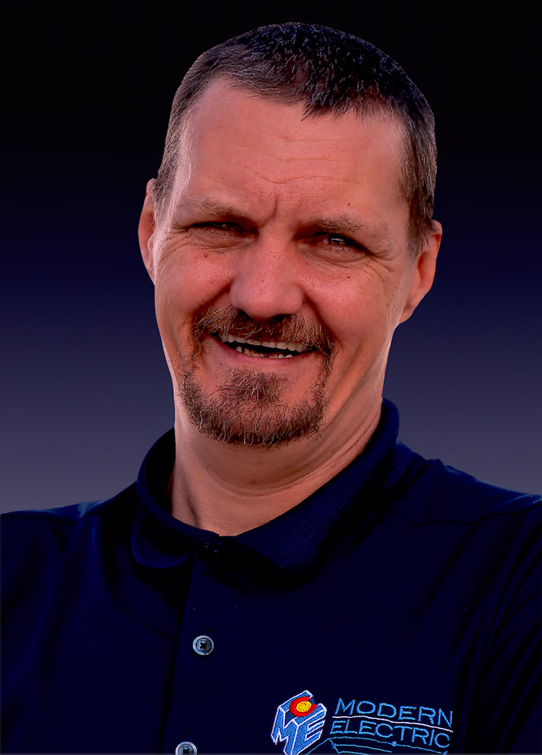Adam, Commercial Foreman at Modern Electric, headshot in a navy company polo