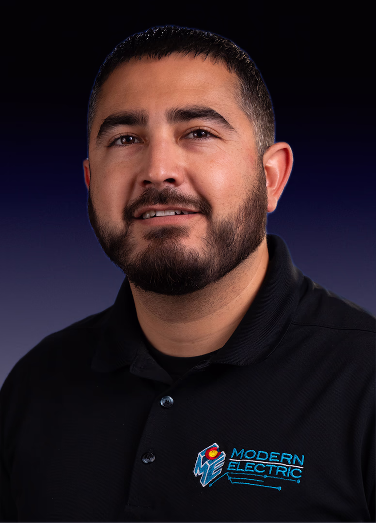 Adrian, Multi-family & Custom Project Manager at Modern Electric, headshot in a black company polo
