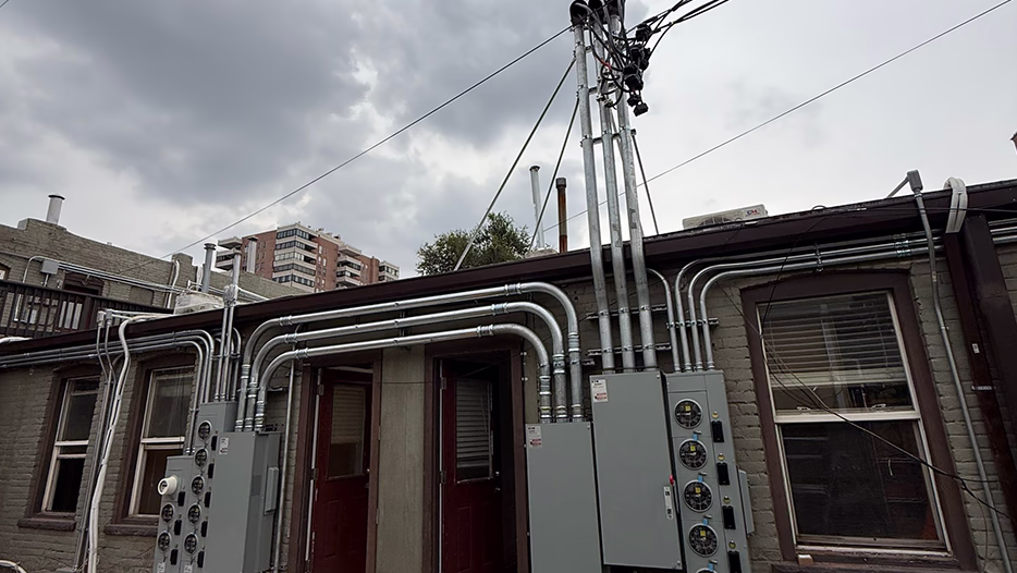 Rooftop electrical service upgrade with metal 
conduit and gray panels on a commercial building by Modern Electric