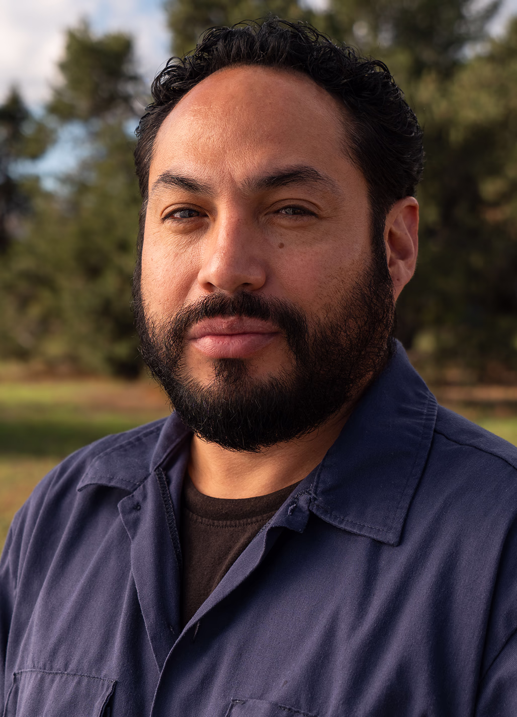 Eddie, Service and Tesla Electrician at Modern Electric, outdoor headshot in a navy work shirt