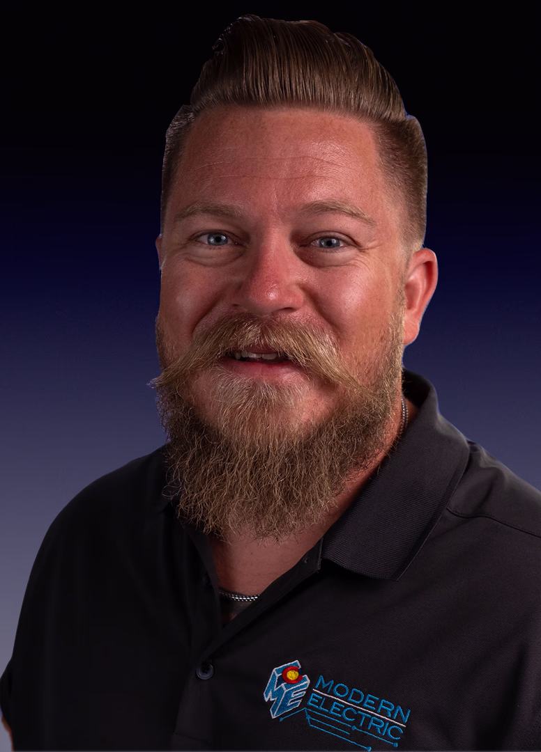 Evan, Insurance and Residential Project Manager at Modern Electric, headshot in a black company polo