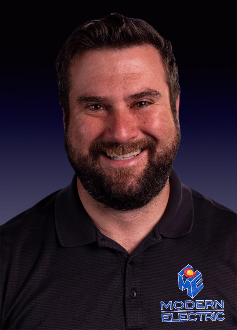 Jason, Master Electrician at Modern Electric, headshot in a black company polo